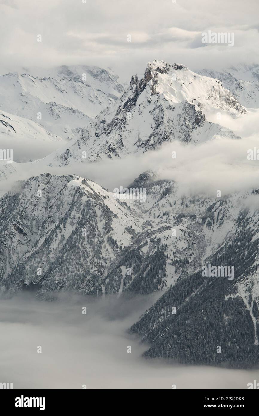 Winter high mountain landscape covered in clouds and snow Stock Photo ...