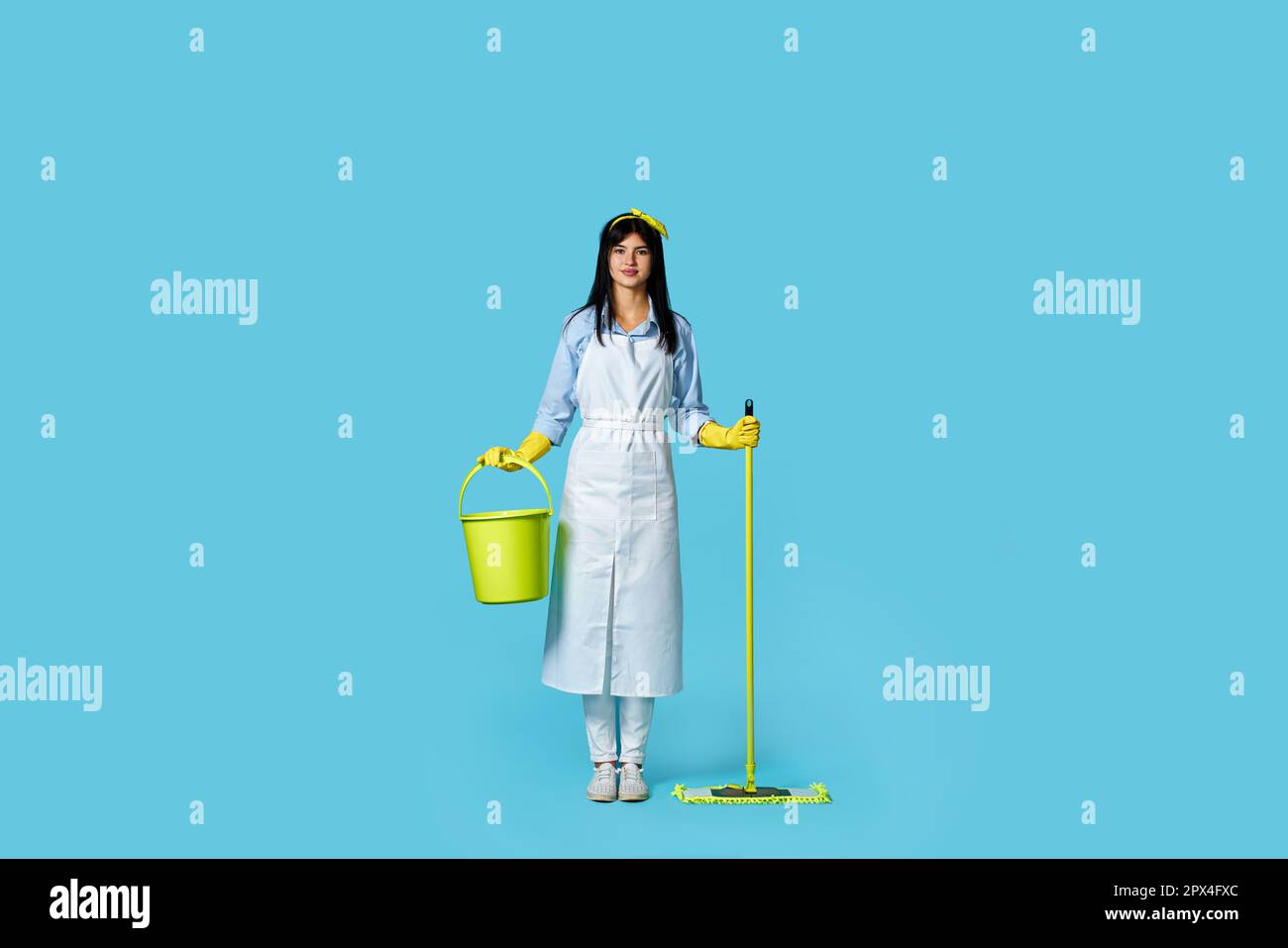 pretty woman in rubber gloves and cleaner apron holding mop and bucket ...