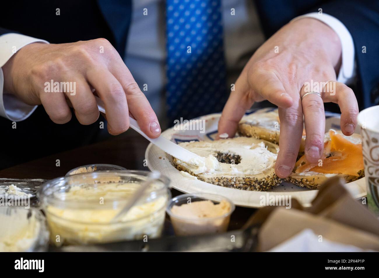Rep. Dan Goldman (DN.Y.) spreads cream cheese onto a bagel in his office on Capitol Hill March
