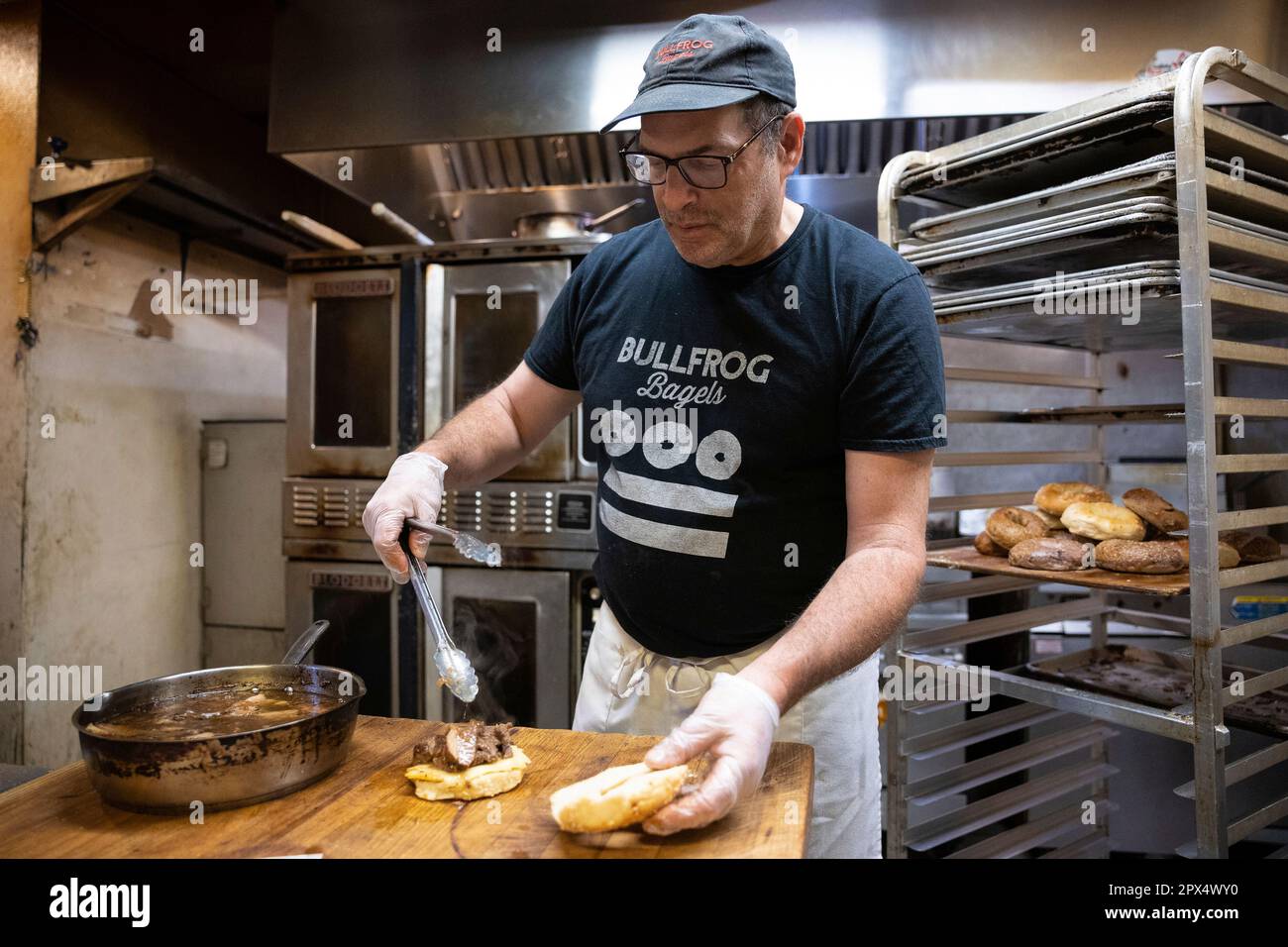 Bullfrog Bagels founder and owner Jeremiah Cohen prepares a bagel