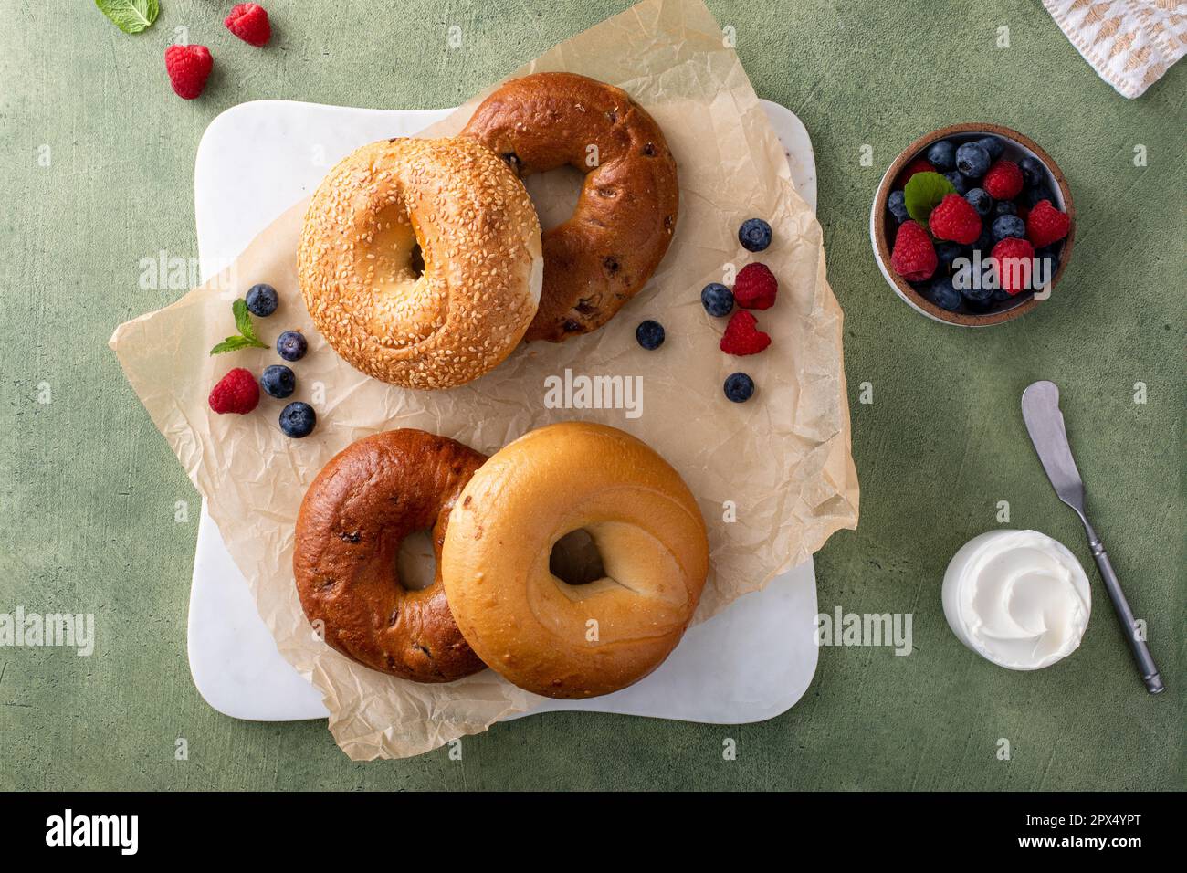 Homemade freshly baked bagels on a parchment paper ready to eat