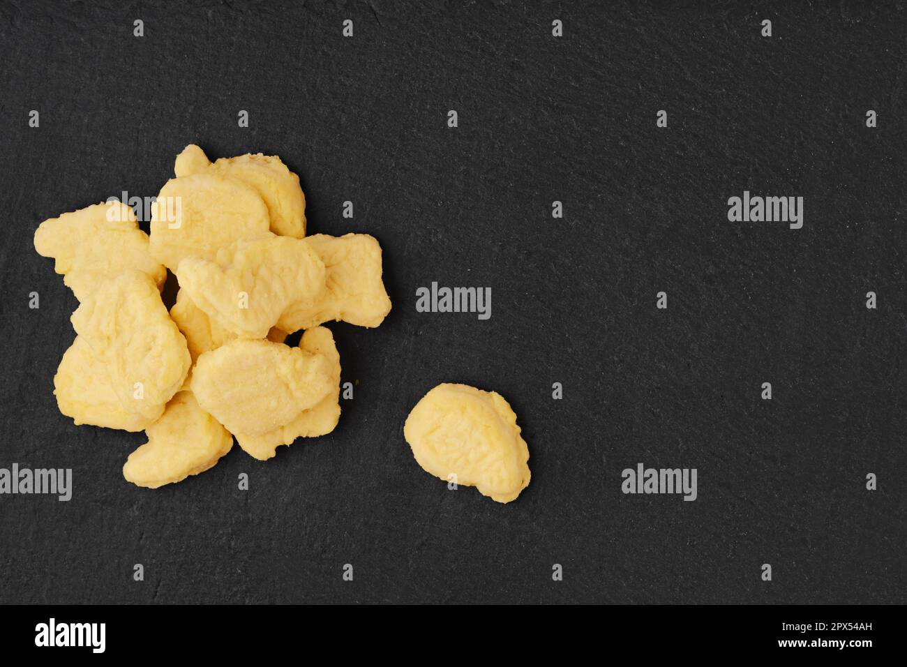 Semifinished frozen chicken nuggets in breading ready for deep frying