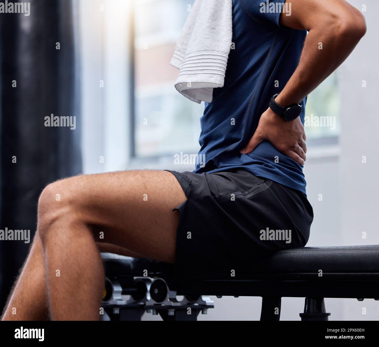 Back pain, fitness and man at gym for training, health and workout