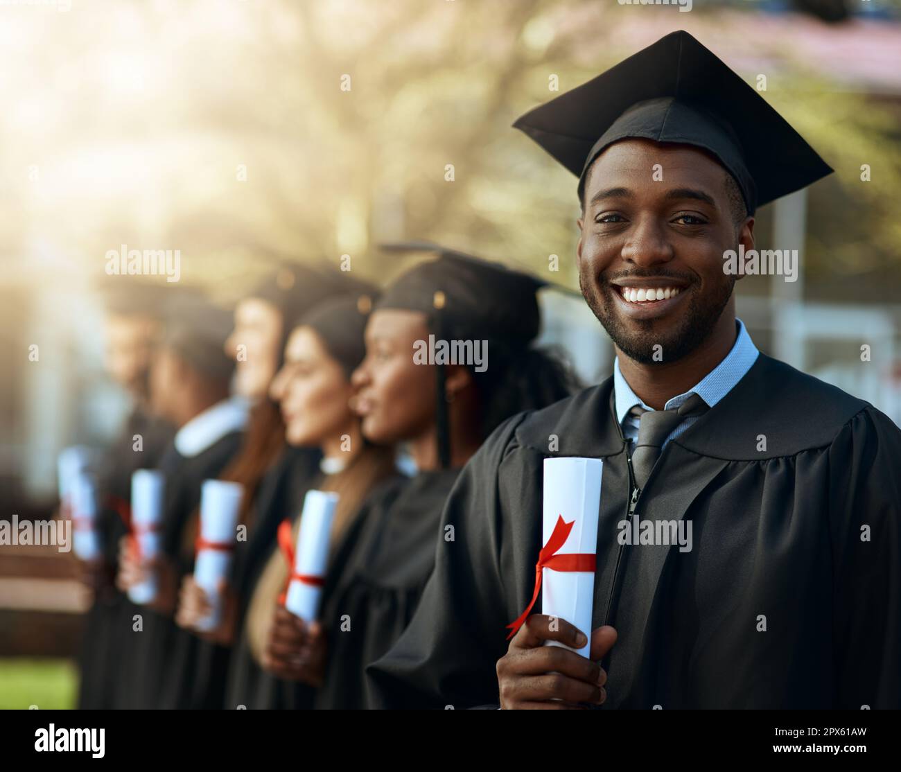Its like gold in my hands. Portrait of a young man holding his diploma