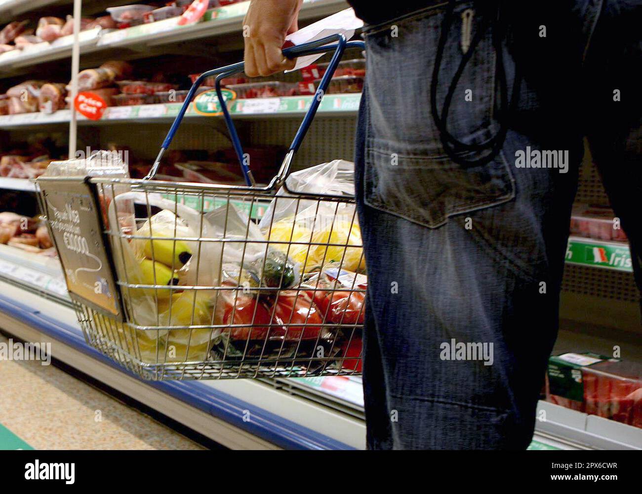 Undated file photo of a person holding a shopping basket in a supermarket. Shop price inflation eased back slightly from record highs last month despite another surge in food prices. Food prices soared 15.7%, the highest on record, in April to continue pressure on consumer finances, according to the latest BRC-NielsenIQ shop price index. Issue date: Tuesday May 2, 2023. Stock Photo
