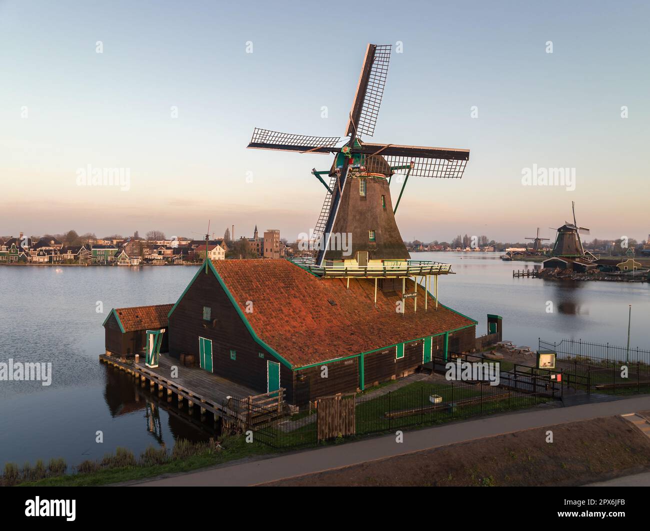 Rural landscape with windmill in Zaanse Schans. Holland, Netherlands. Authentic Zaandam mill. Beautiful Netherland landscape. Stock Photo