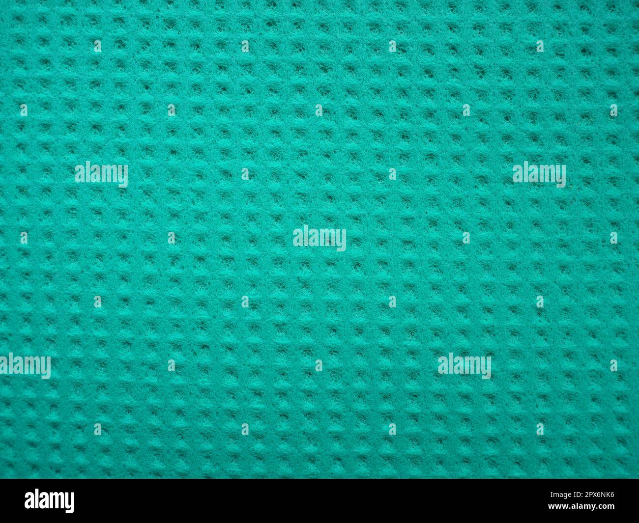 Sponge fibers sponge texture pattern surface close-up green background. Stock Photo