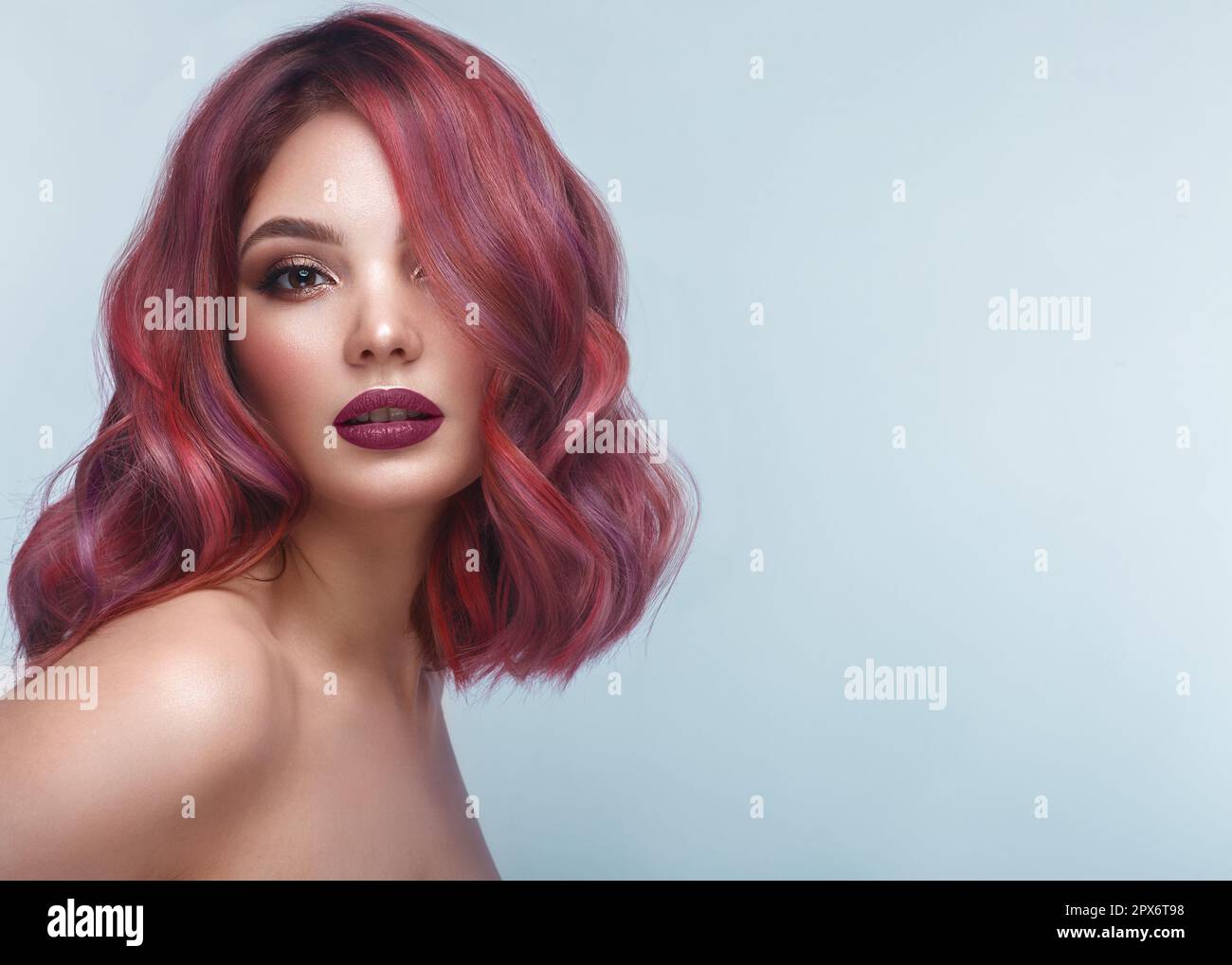 Beautiful girl with multi-colored hair and classic make-up and hairstyle. Beauty face. Photo taken in the studio Stock Photo