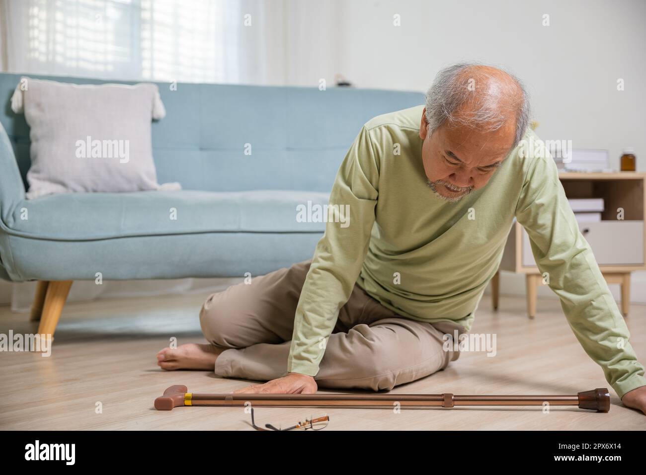 Older senior man headache lying on the floor after falling down he pain