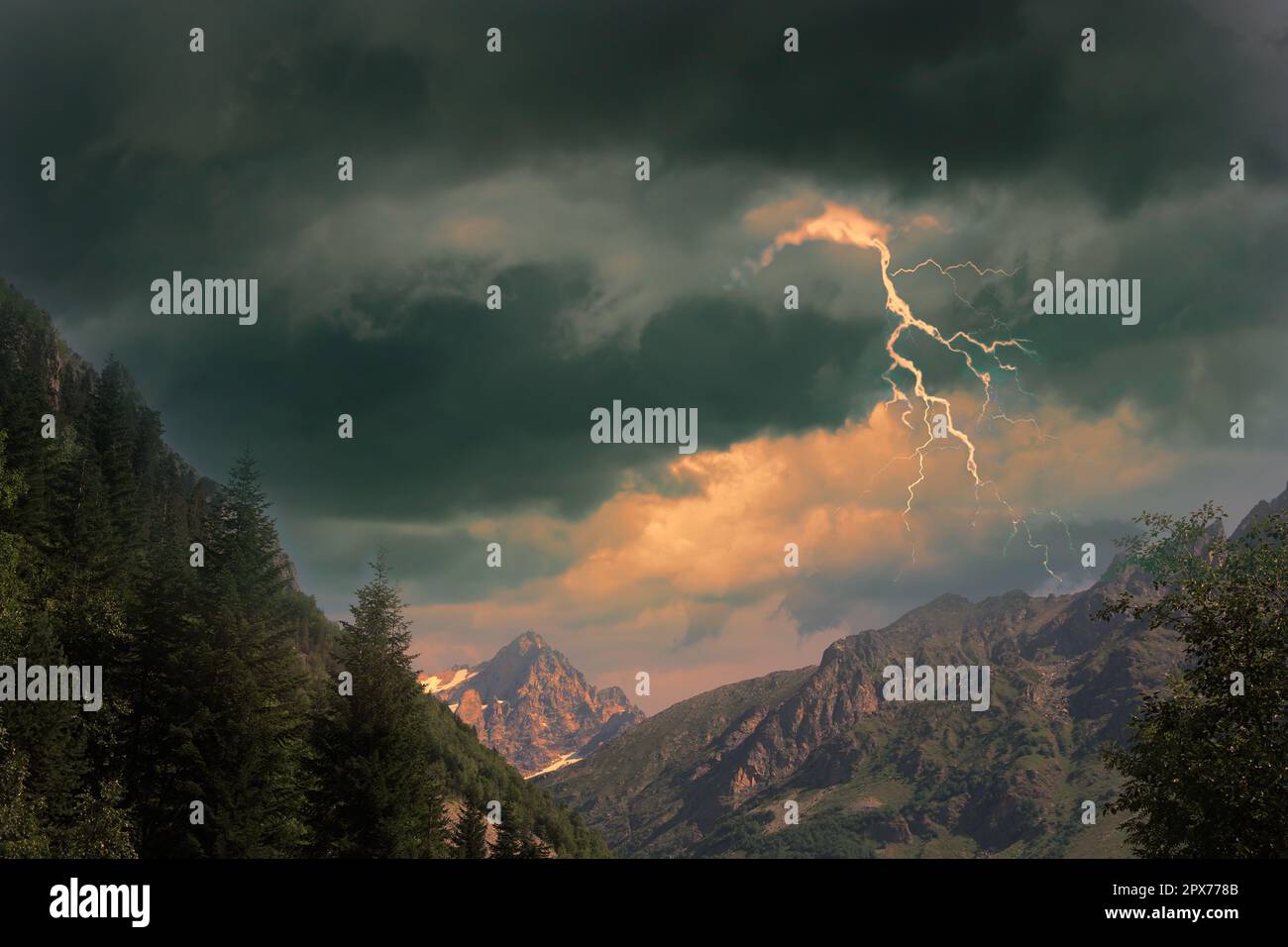 Dark cloudy sky with lightnings over beautiful mountains. Thunderstorm Stock Photo