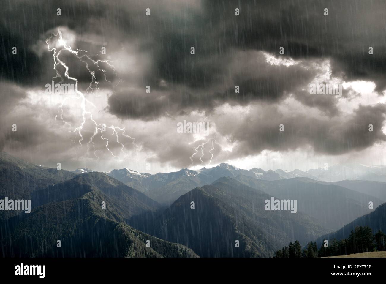 Dark cloudy sky with lightnings and rain over beautiful mountains forest. Thunderstorm Stock Photo