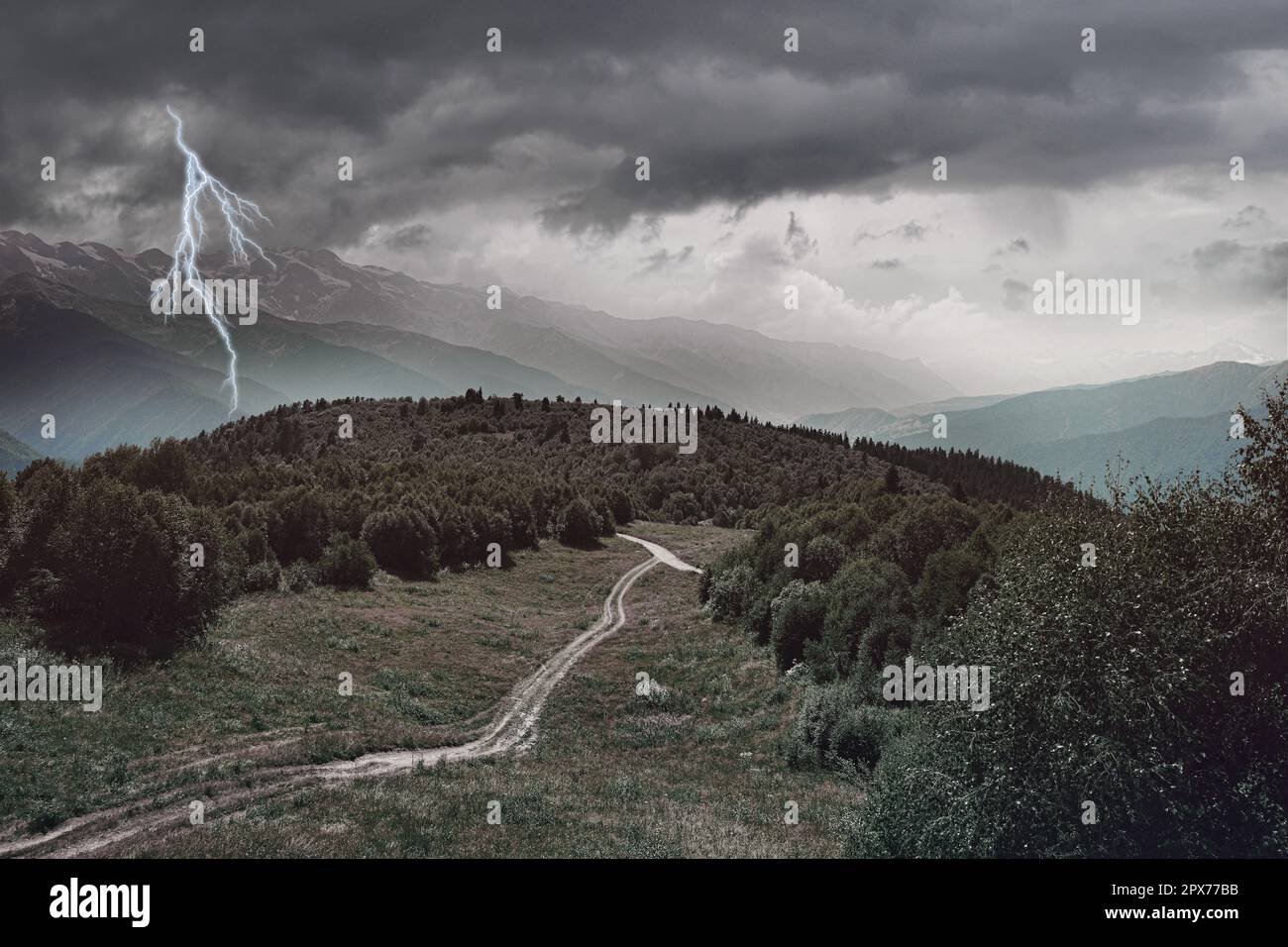 Dark cloudy sky with lightnings over field, plants, trees and mountains. Thunderstorm Stock Photo