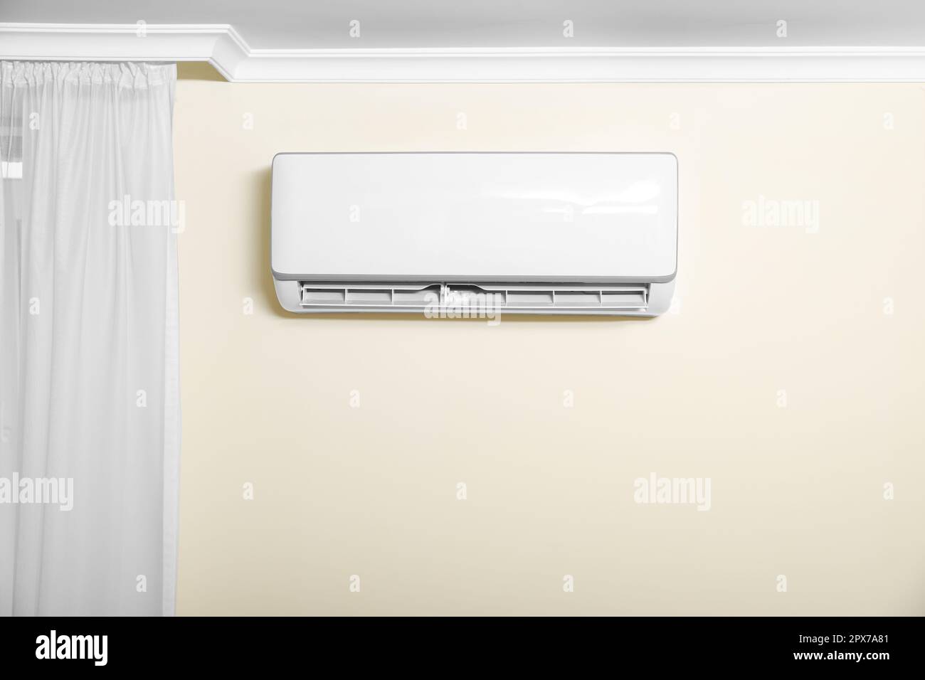 Modern air conditioner on white wall indoors Stock Photo - Alamy