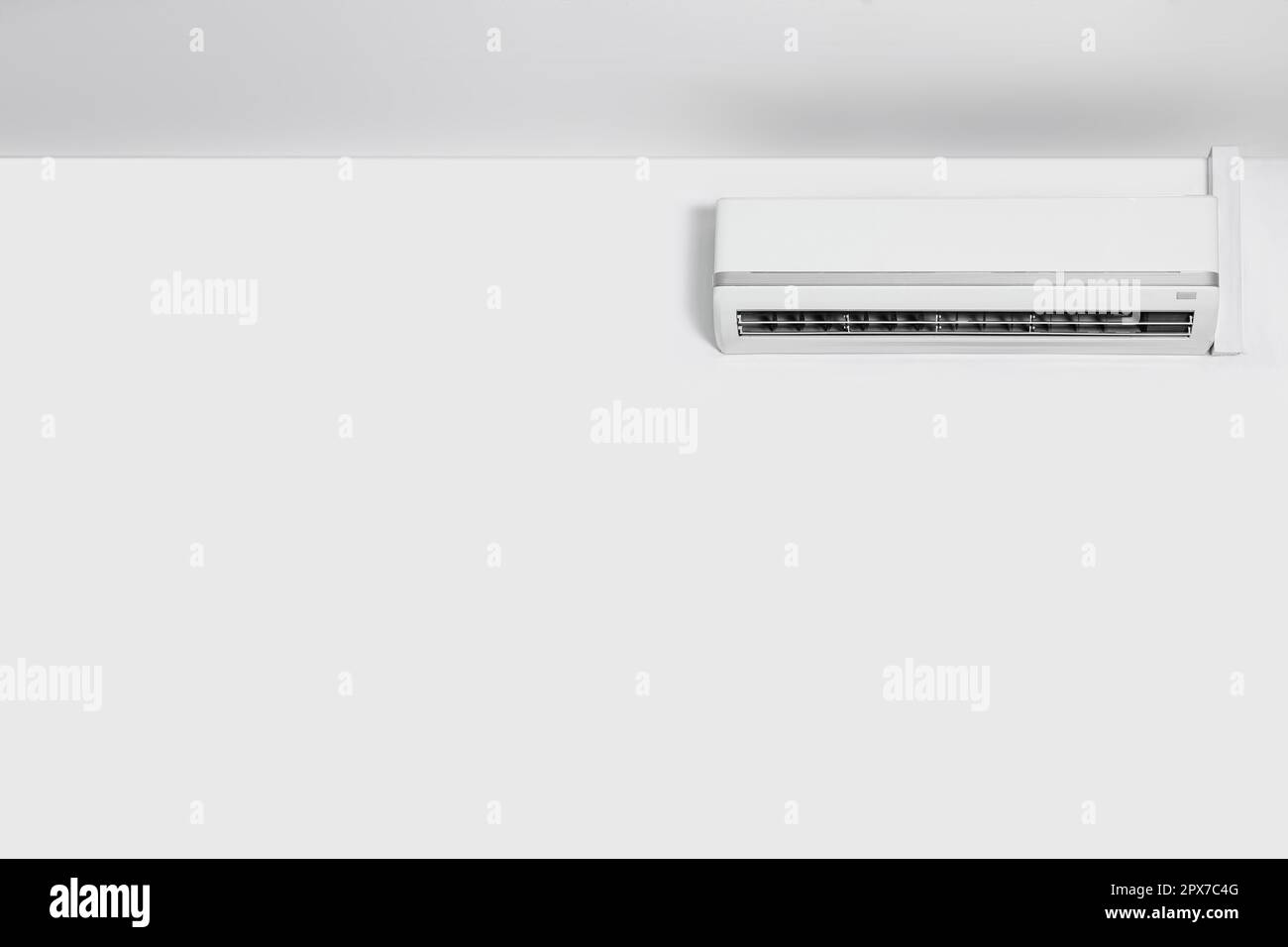 Modern air conditioner on white wall indoors Stock Photo - Alamy