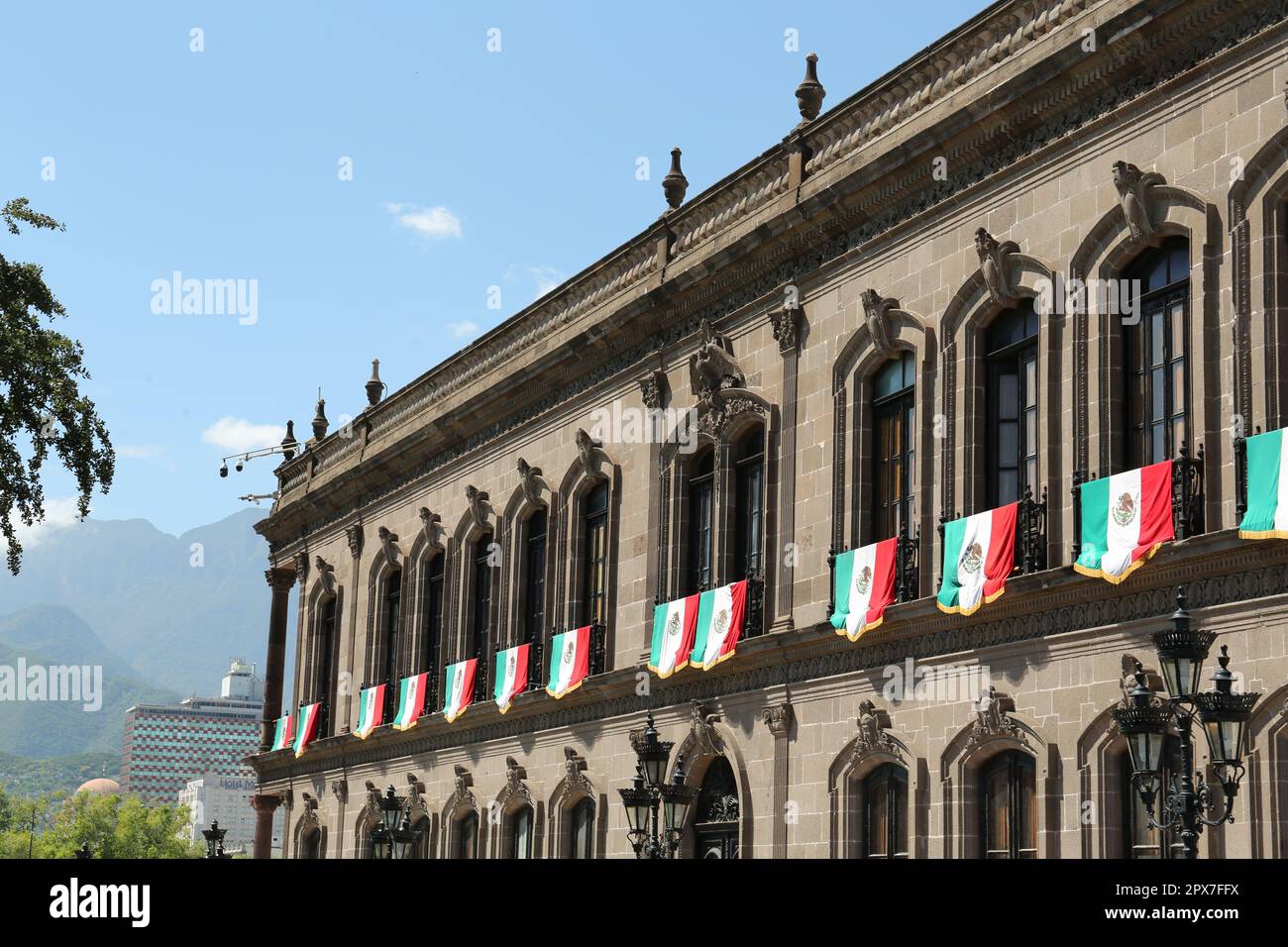 MONTERREY (NUEVO LEON), MEXICO - SEPTEMBER 29, 2022: Beautiful view of Palacio de Gobierno (Government Palace) with flags on sunny day Stock Photo