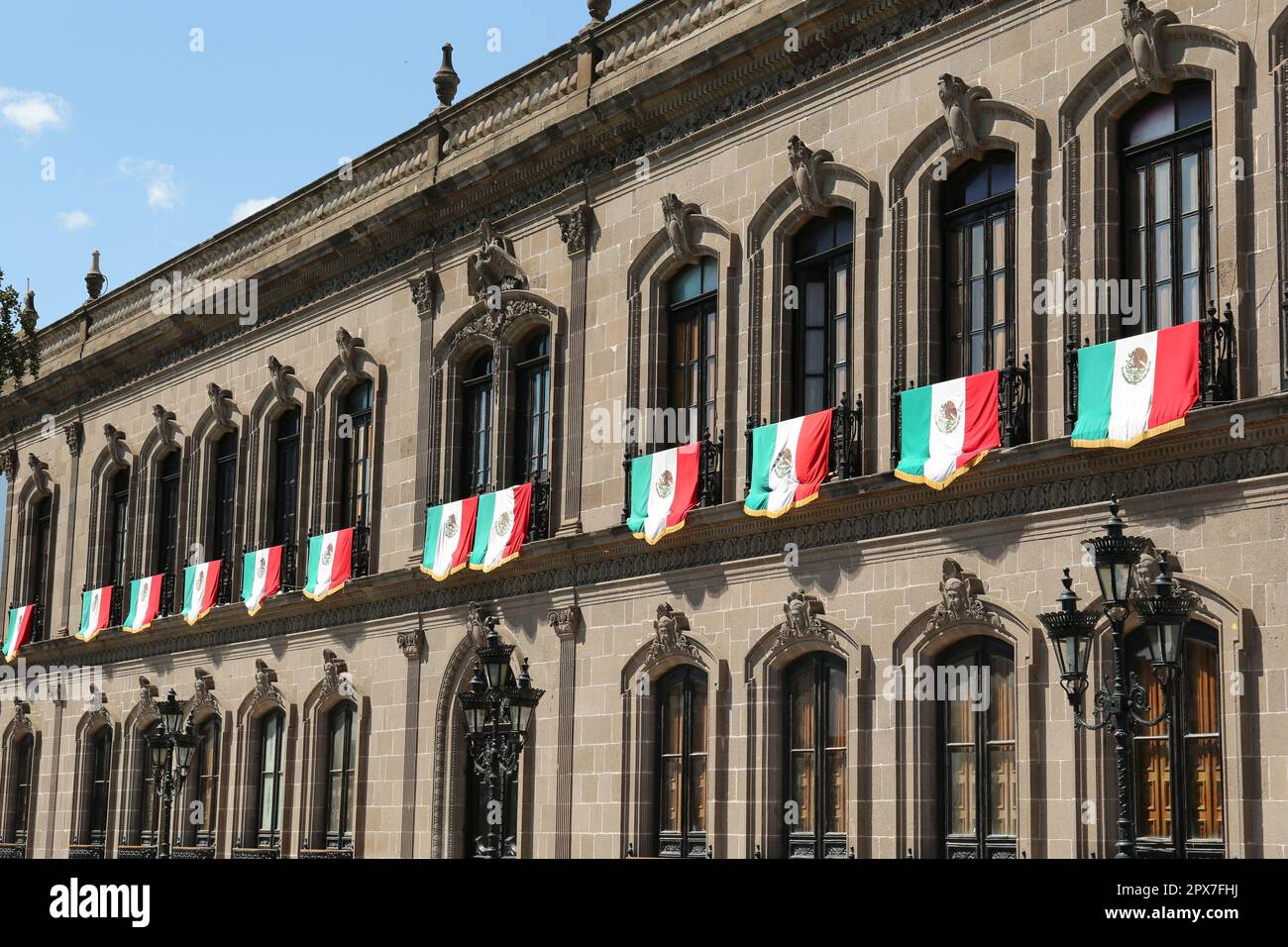 MONTERREY (NUEVO LEON), MEXICO - SEPTEMBER 29, 2022: Beautiful view of Palacio de Gobierno (Government Palace) with flags on sunny day Stock Photo