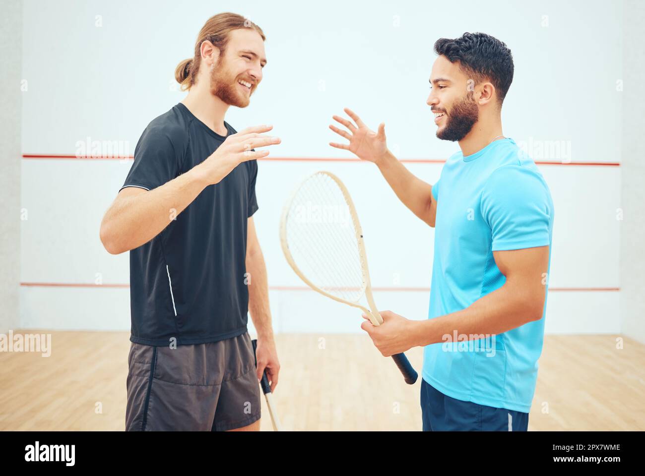 Two athletic squash players shaking hands before court game. Team of