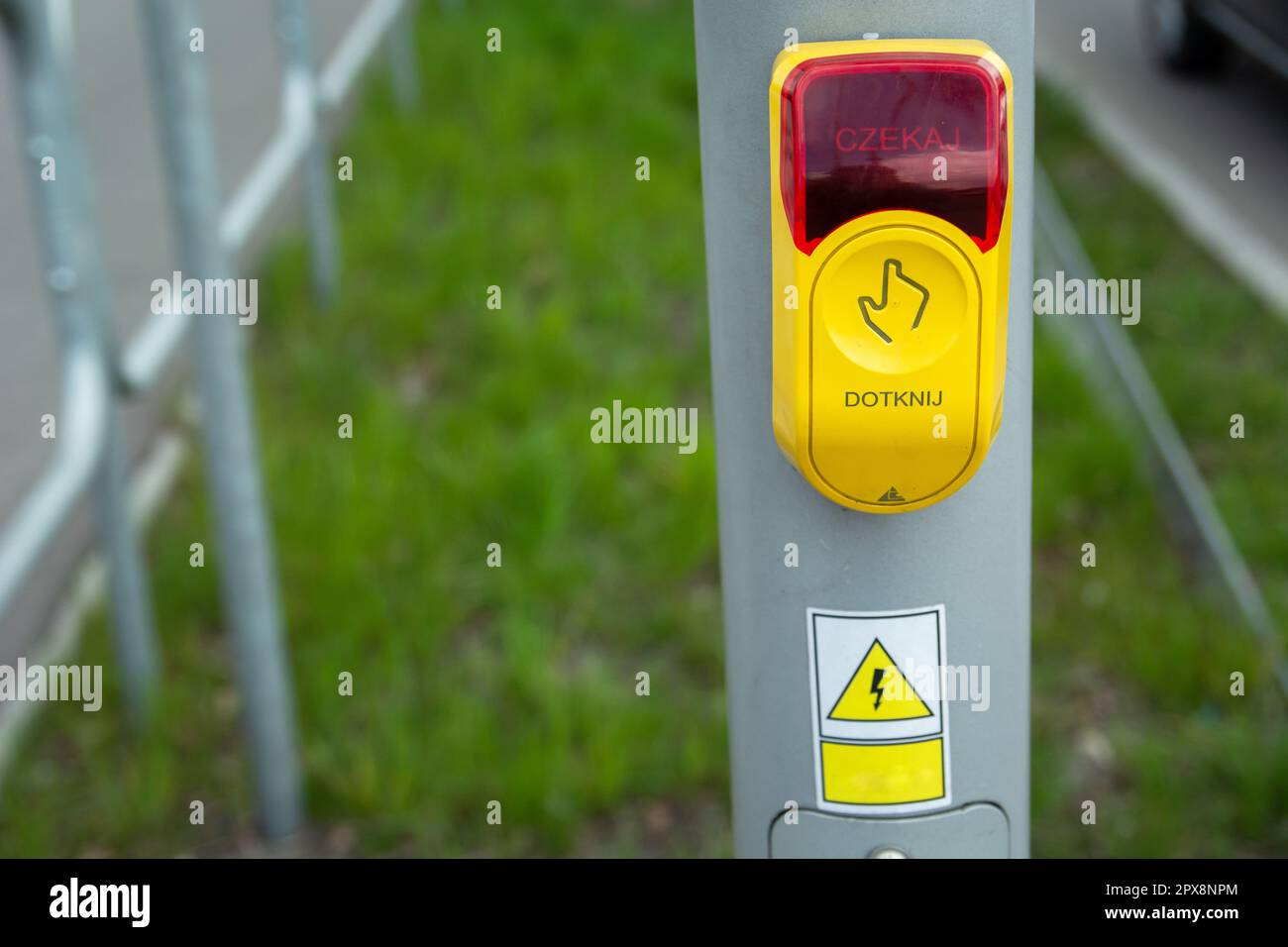 Yellow-red traffic light button touch and wait in Polish language Stock Photo