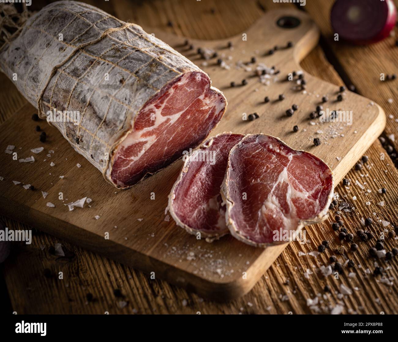 Cured coppa coated in noble mold on rustic wooden background Stock Photo