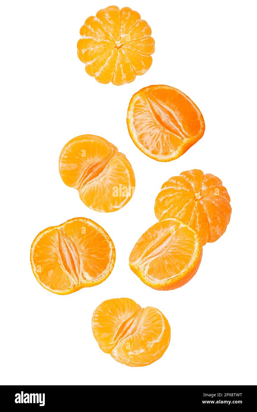 Isolated flying grapes. Seven whole and sliced mandarin fruits falling