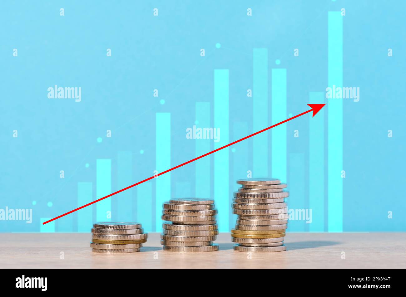 A stack of coins and a graph with growing numbers, high margins and income Stock Photo