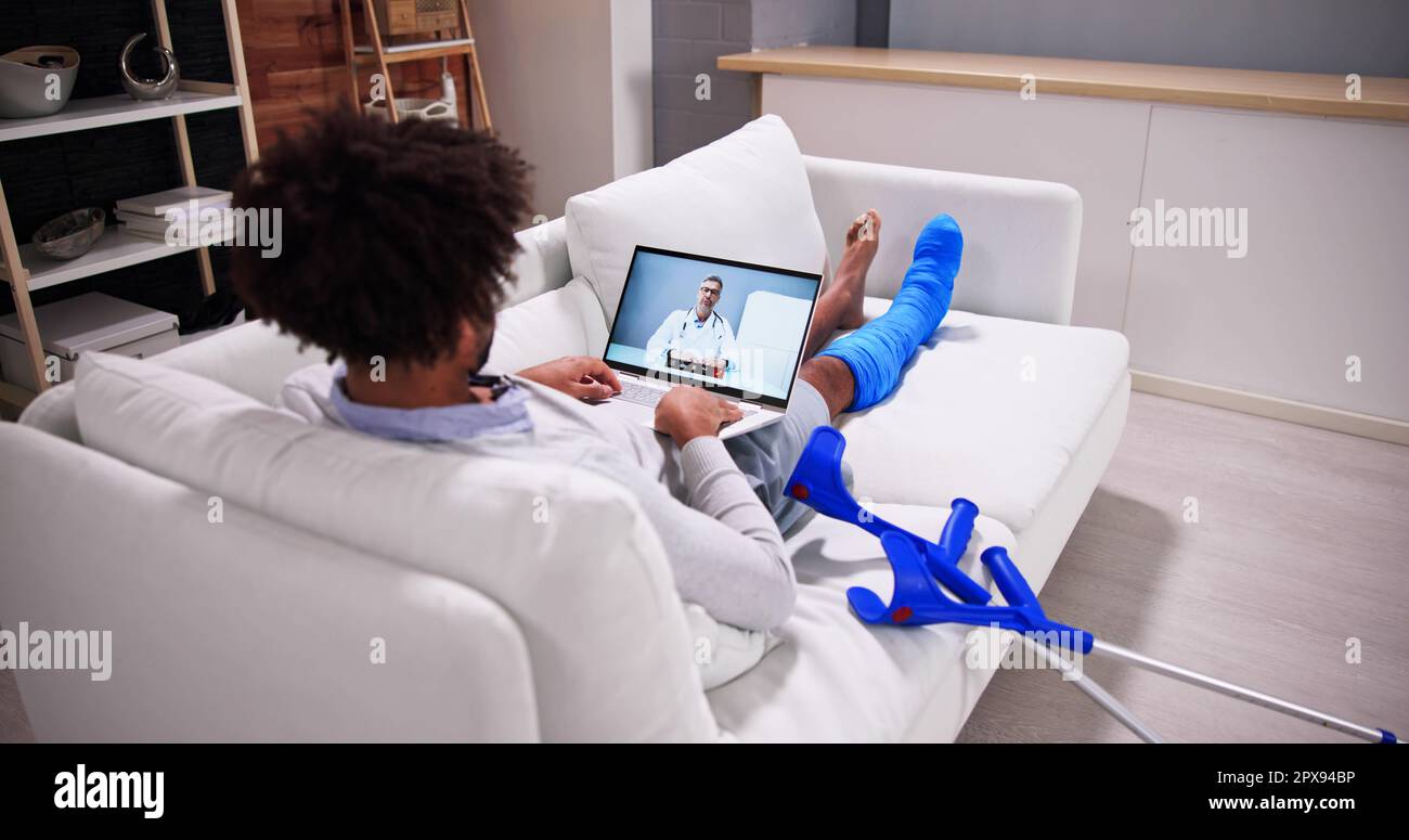 African Patient Conferencing Online With Telemedicine Doctor Stock Photo