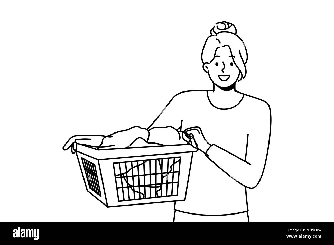 Smiling young woman with basket with clothes going to laundry. Happy
