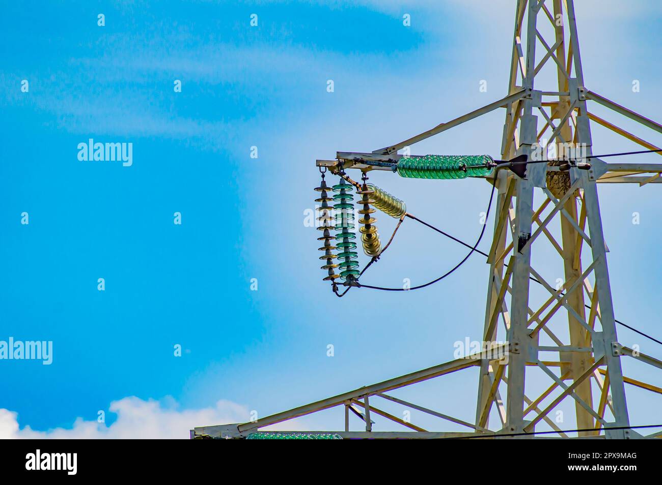 Line insulator on the electrical wires of a high-voltage tower. Electric wires. High-voltage power transmission tower. Electrical line insulators. Ene Stock Photo