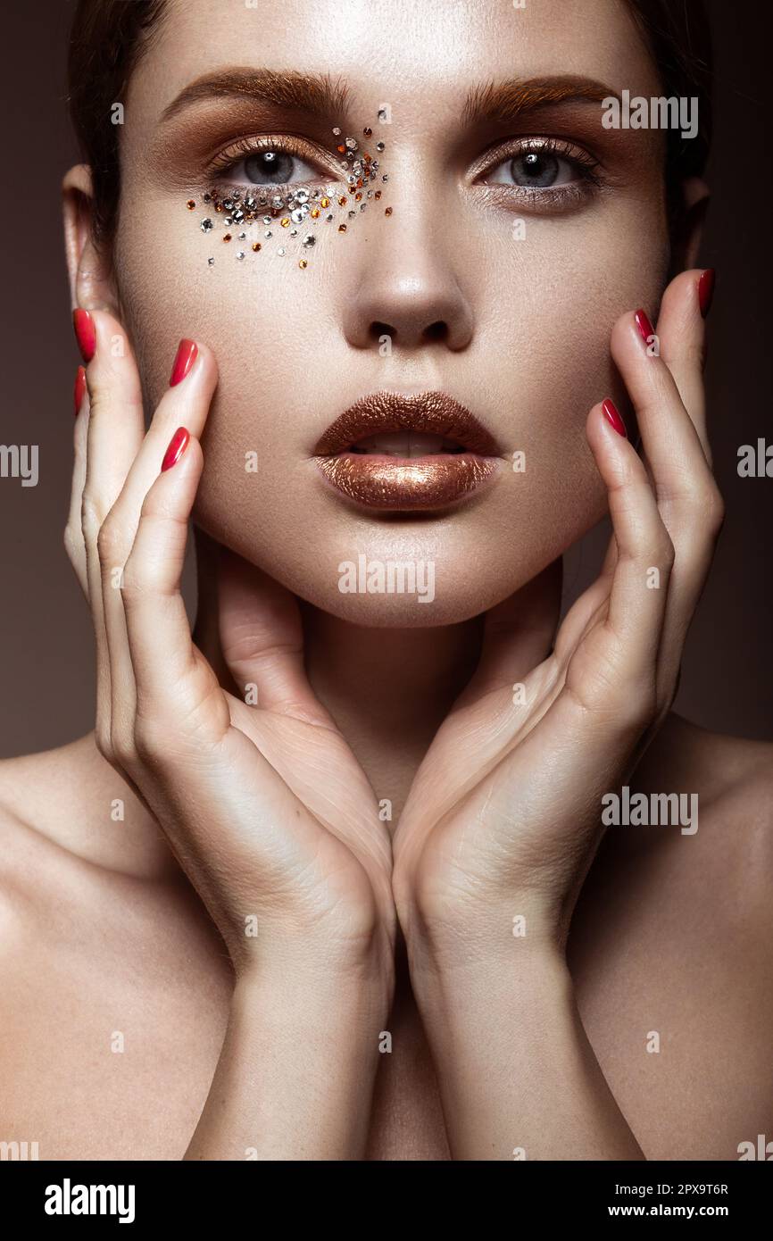 Beautiful girl with a gentle make-up and crystals on the face. Beauty face.  Picture taken in the studio Stock Photo - Alamy, image size:866x1390