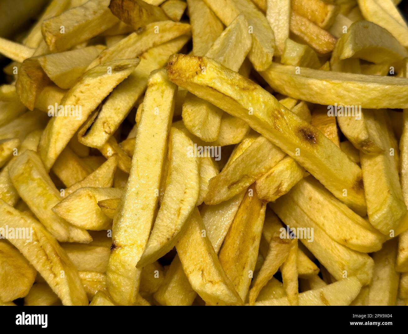 Fries in oil. Freshly baked potato chips. food background Stock Photo