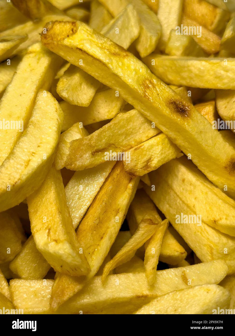 Fries in oil. Freshly baked potato chips. food background Stock Photo