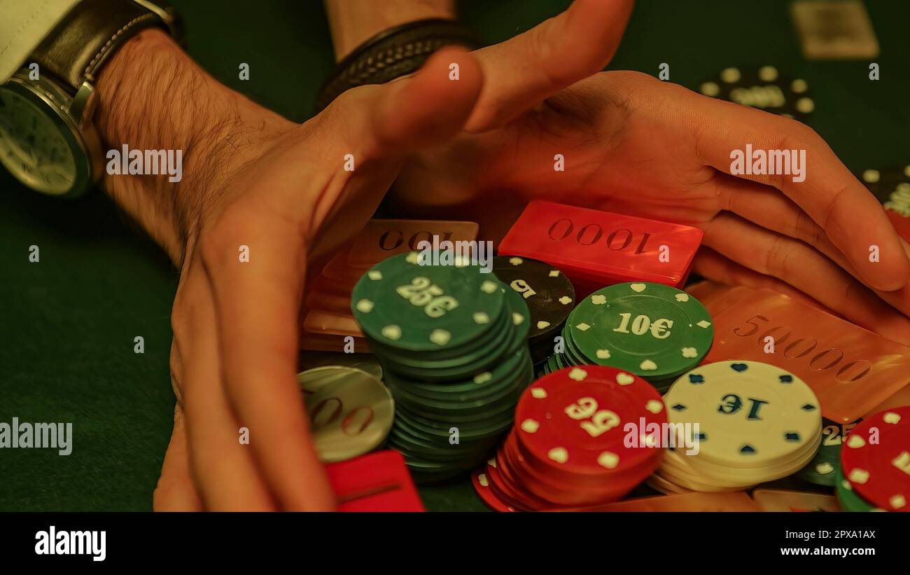 a-dramatic-moment-in-a-high-stakes-poker-game-as-all-the-chips-or-fiches-are-pushed-forward-signaling-an-all-in-bet-representing-the-high-stakes-2PXA1AX.jpg