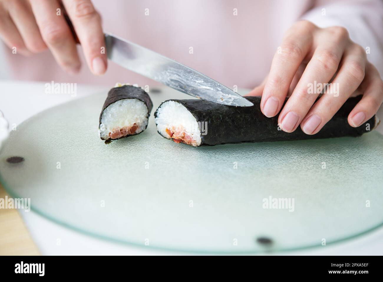 The process of making sushi, the girl makes sushi with different ...