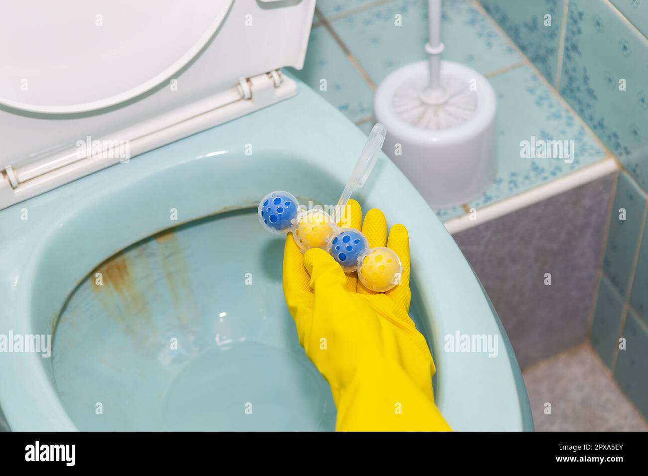 A yellowblue plastic toilet block that cleans the walls of the toilet