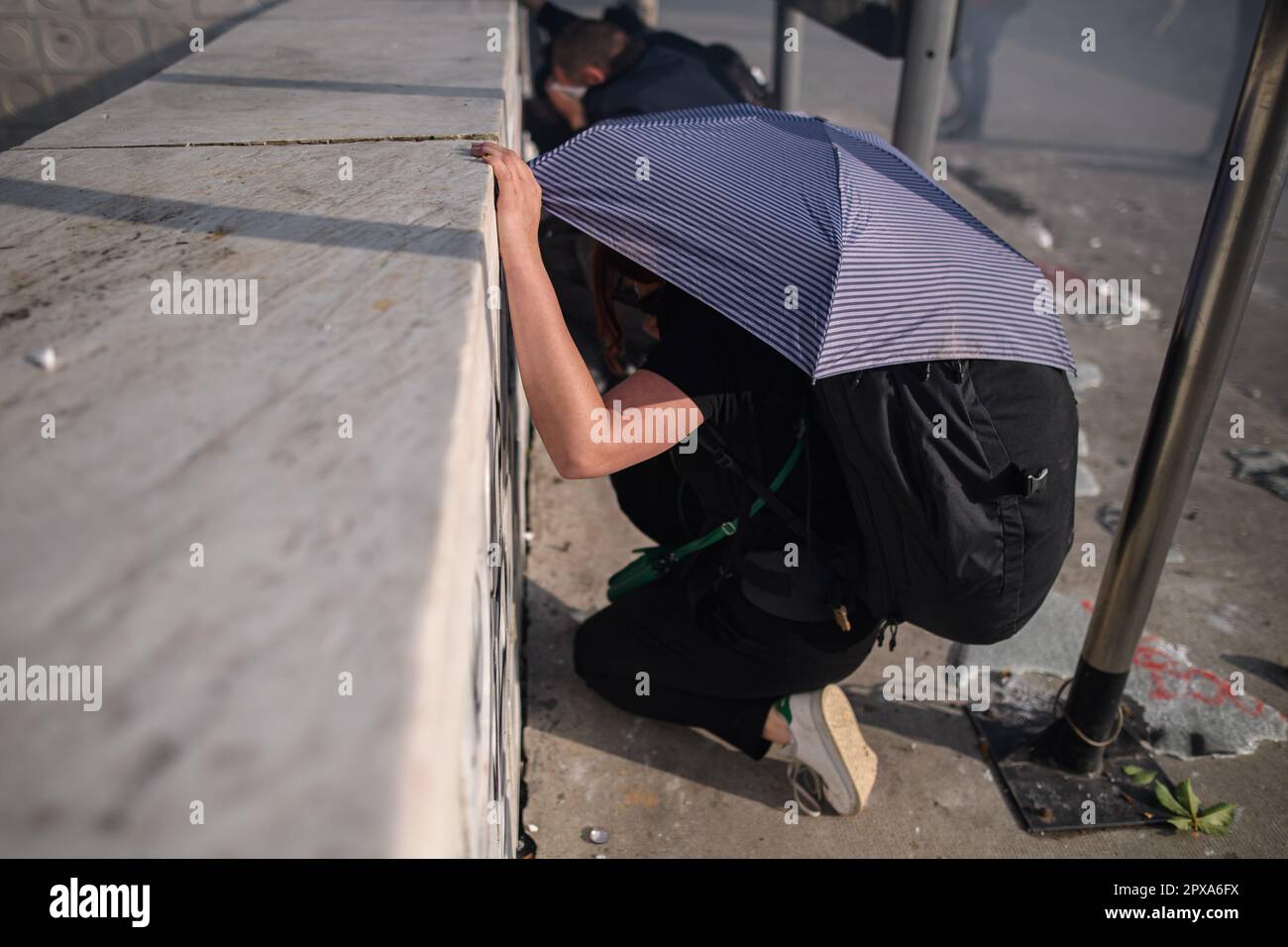 Paris, France. 1st May, 2023. Demonstrators protect themselves from LBD
