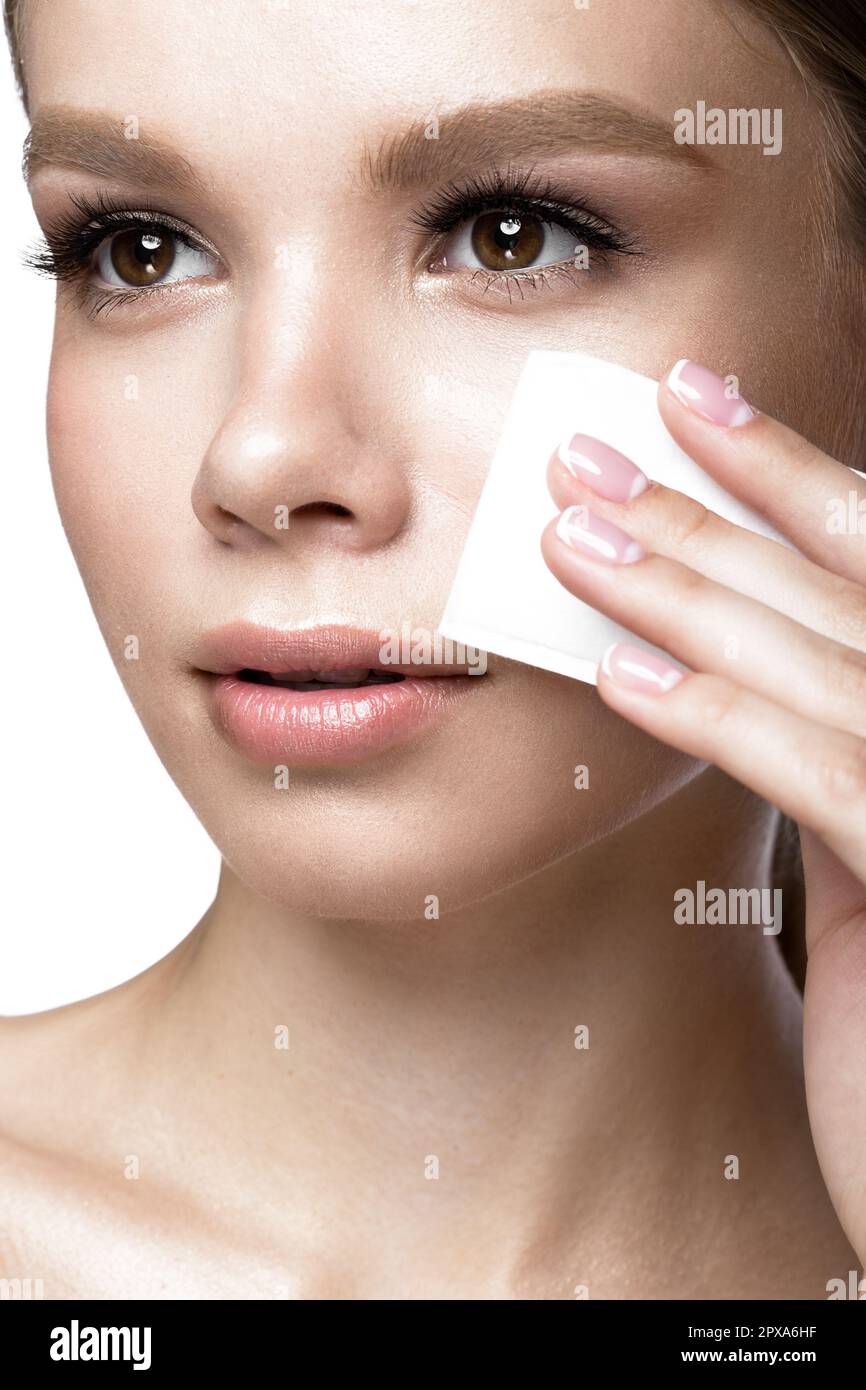Beautiful young girl with wipes for removing makeup and French manicure. Beauty face. Picture