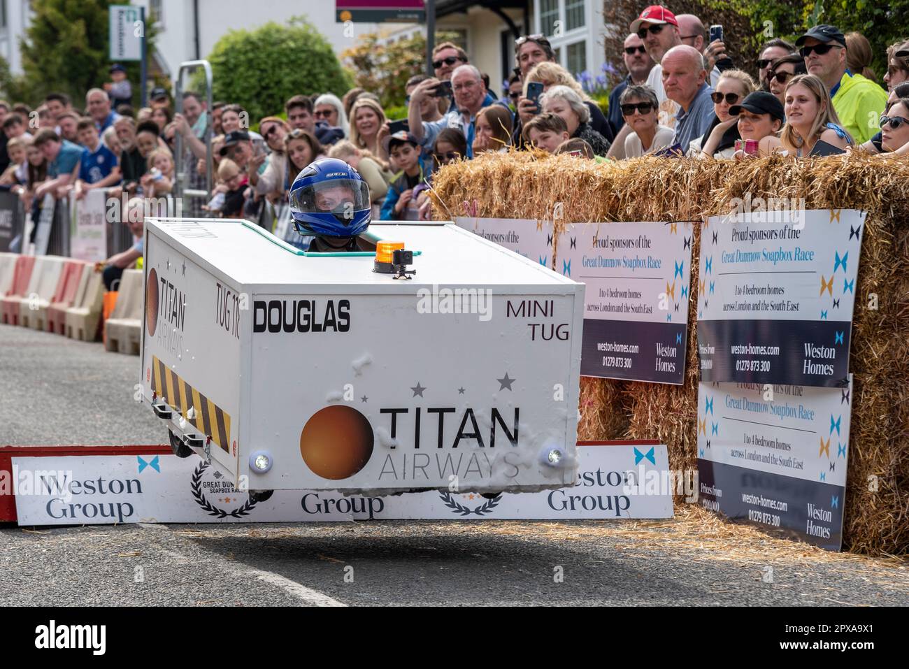 Titan Engineering team cart competing in the Great Dunmow soapbox race 2023, Essex, UK. Taking the jump ramp. Douglas tug shaped cart Stock Photo