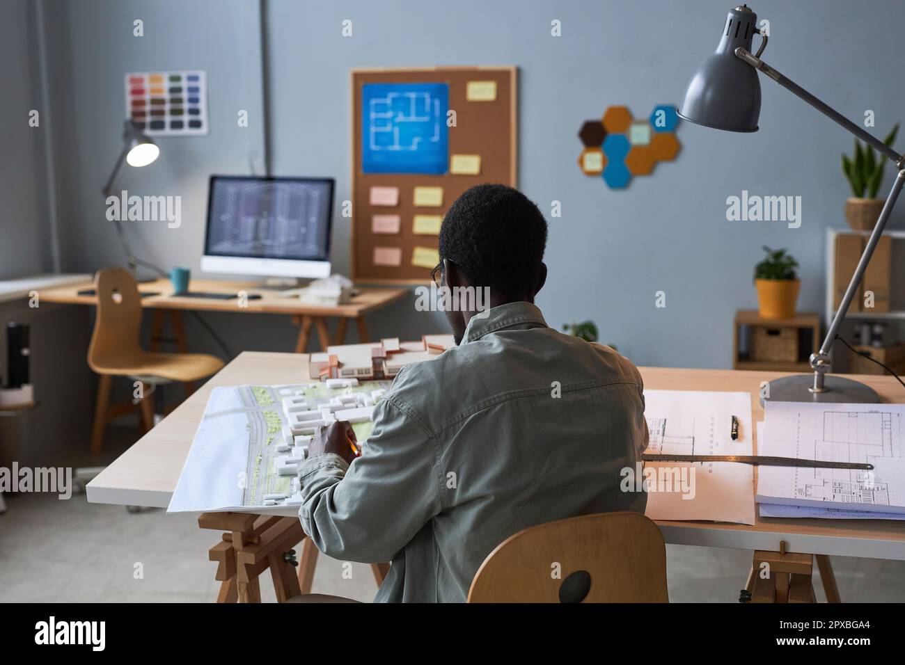 Rear view of African American engineer developing project of building ...
