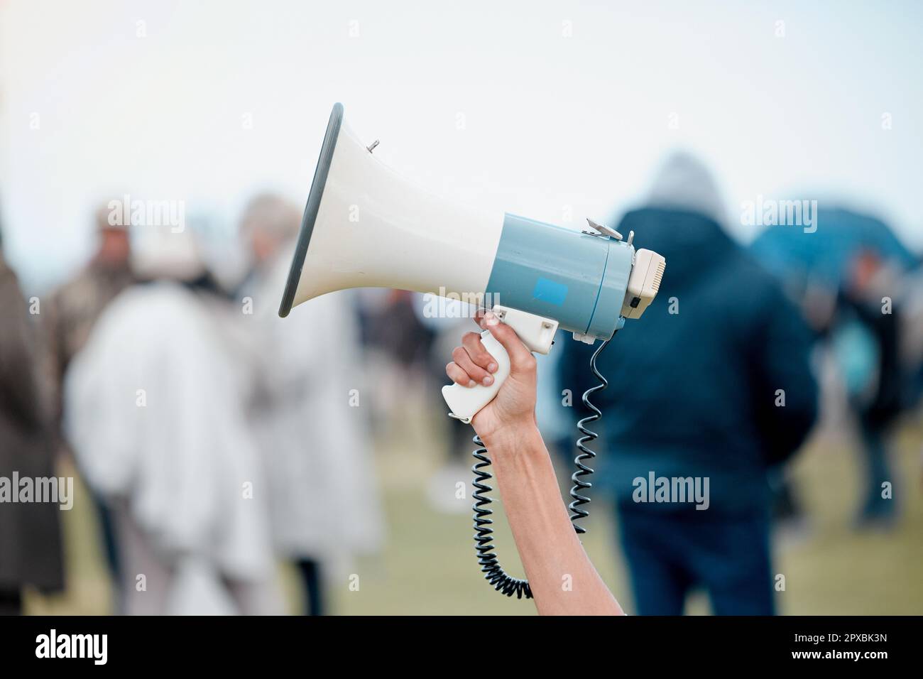 Hear our rage Mr President. Cape Town, South African - October 2, 2021 An unrecognisable demonstrator holding up a megaphone in protest. Stock Photo