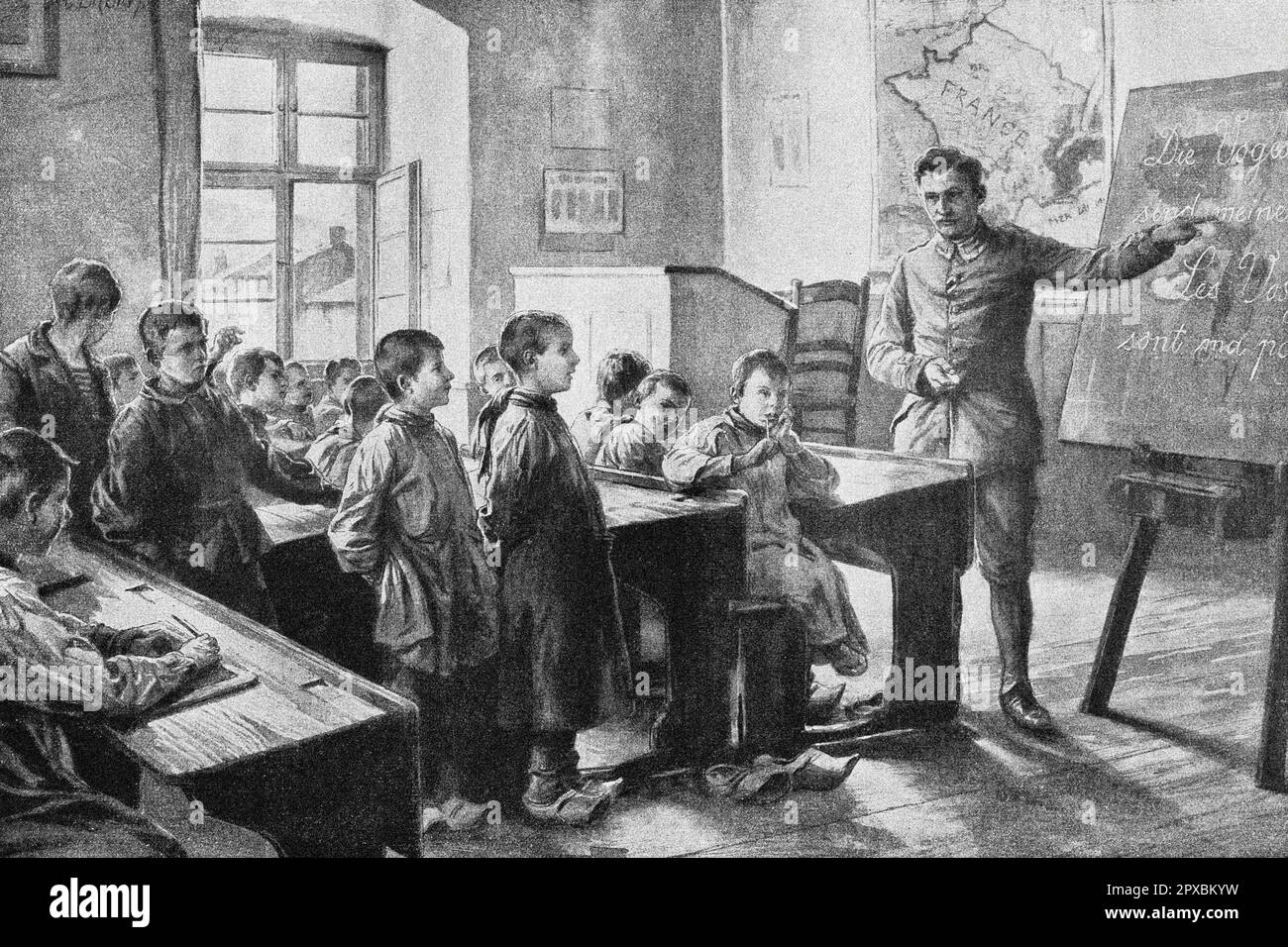 World War I. War and culture. German culture in enemy territory: a Strasbourg elementary school teacher conscripted for military service gives German lessons in a village school of the French Vosges. 1914 Stock Photo