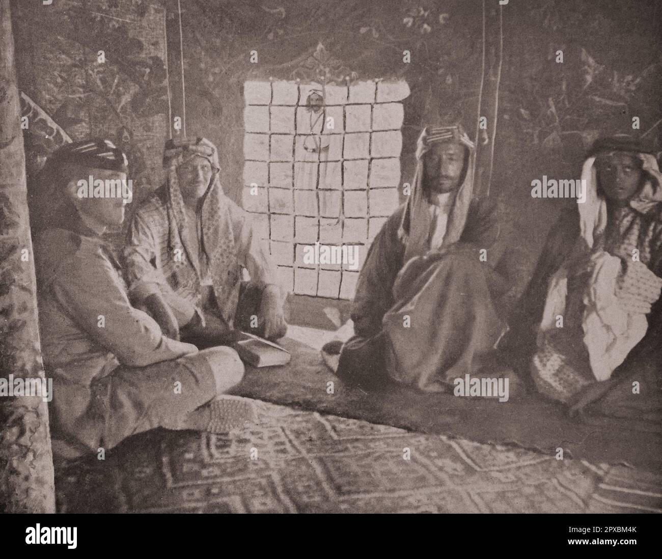 World War I. Middle East. In the Hejaz. Emir Faisal.  One of the sons of the king of Hejaz: the emir Faisal in his tent.  Faisal I bin Al-Hussein bin Ali Al-Hashemi (1885–1933) was King of the Arab Kingdom of Syria or Greater Syria in 1920, and was King of Iraq from 23 August 1921 until his death. He was the third son of Hussein bin Ali, the Grand Emir and Sharif of Mecca, who was proclaimed as King of the Arabs in June 1916.  He was a 38th-generation direct descendant of Muhammad, as he belonged to the Hashemite family. Stock Photo
