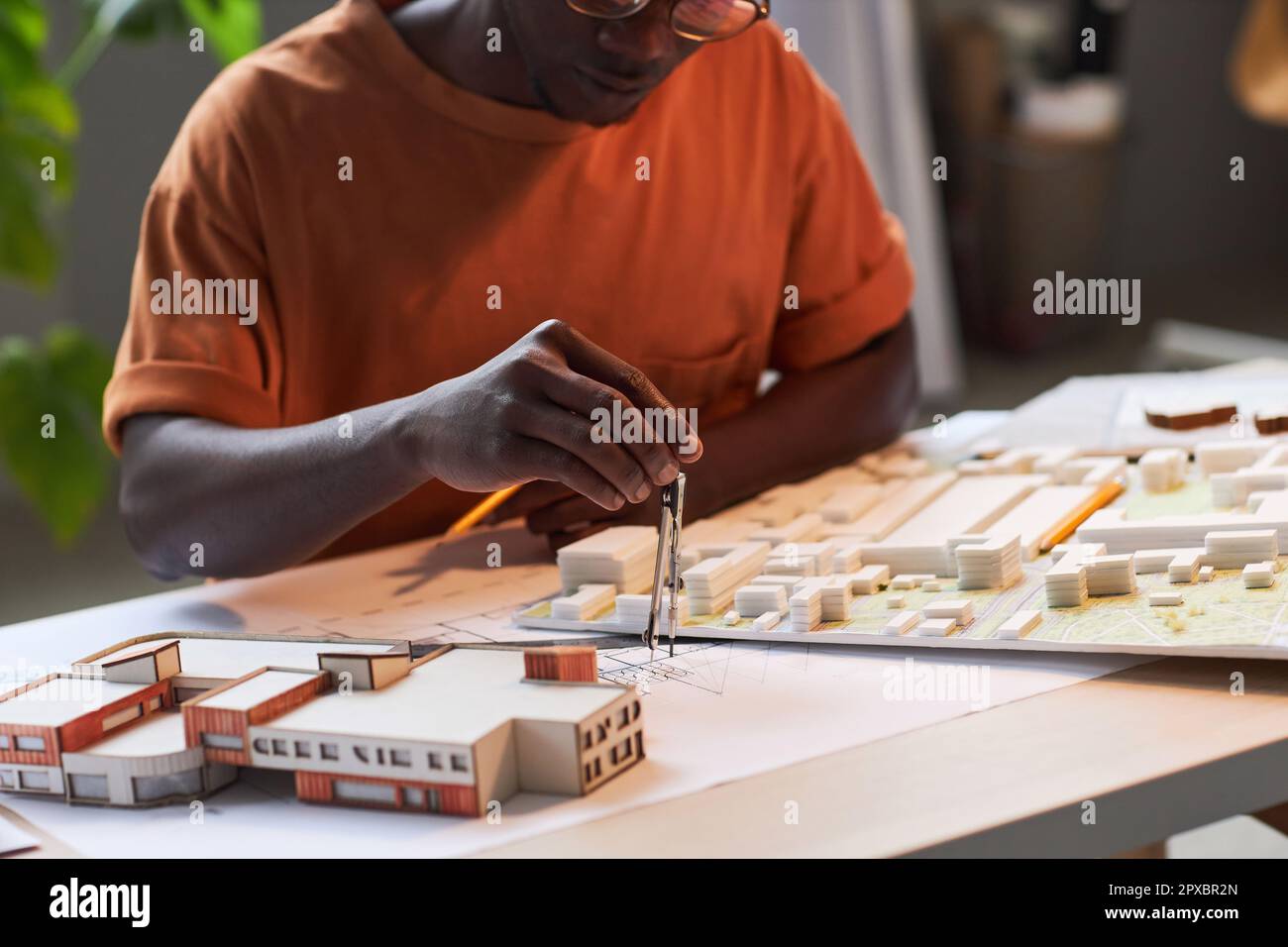 African American engineer drawing blueprint of construction while ...