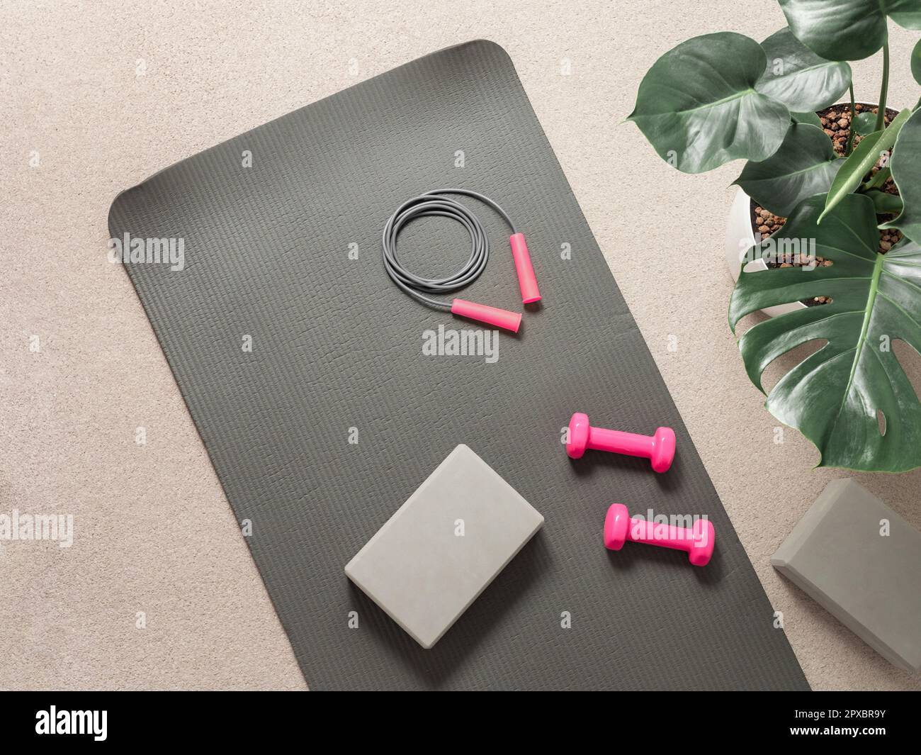 Stylish gray and pink home fitness flat lay. Top view of gray