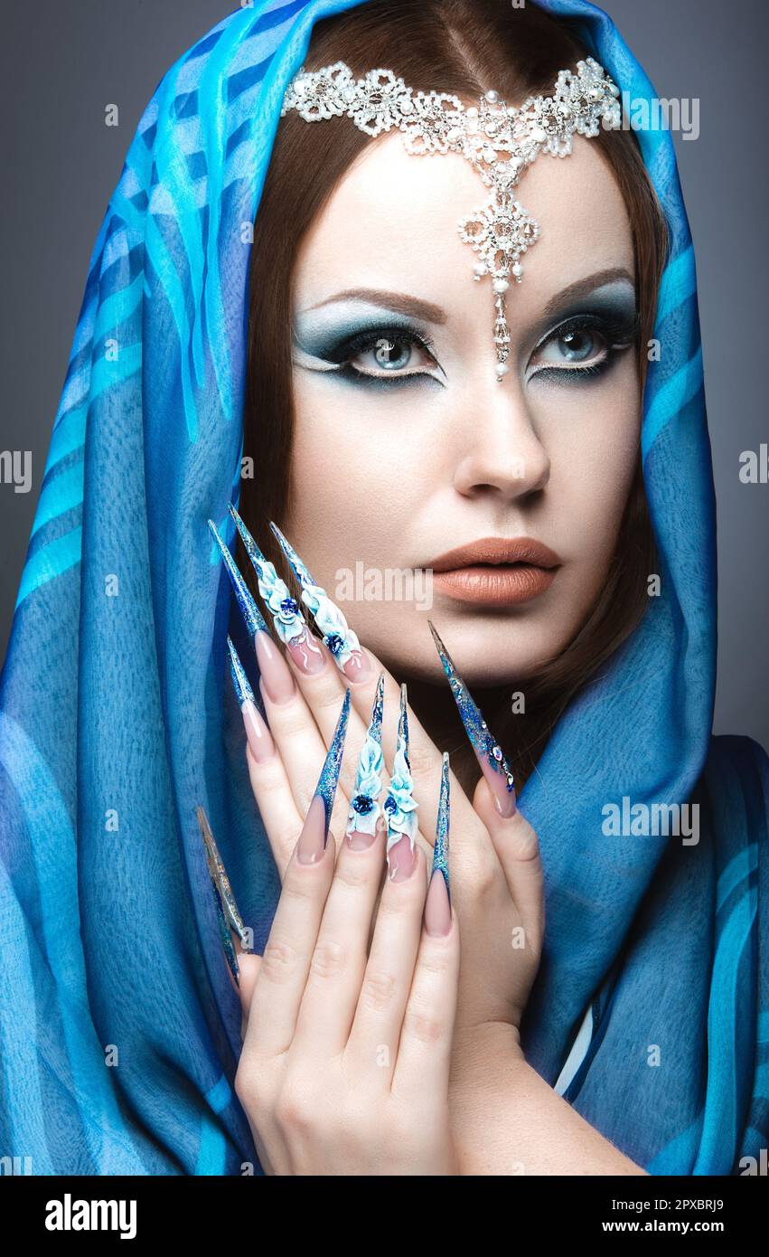 Beautiful girl in eastern Arabic image with long nails and bright blue