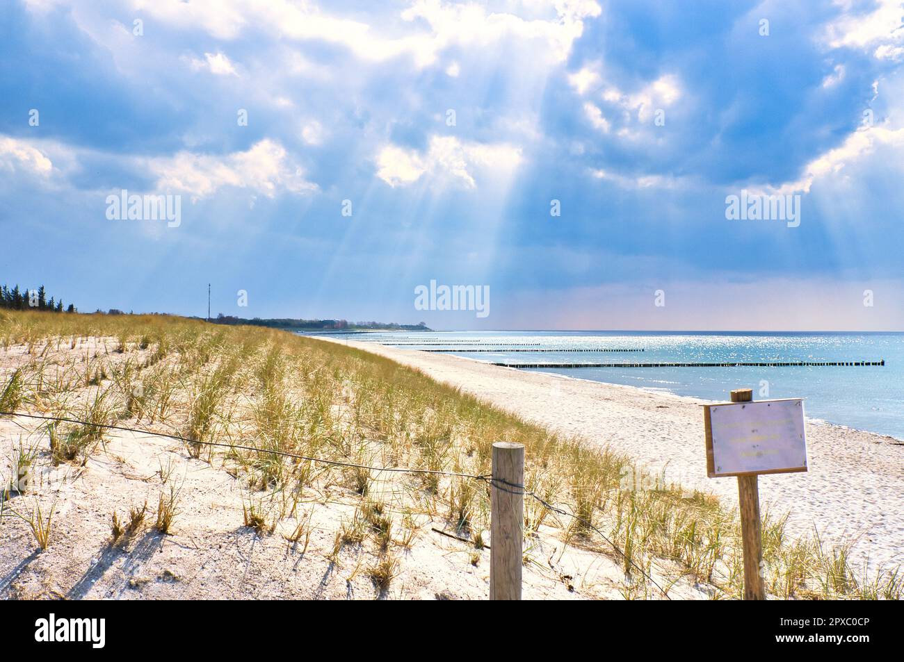 Sun rays shining through thick clouds on the beach of the Baltic Sea ...