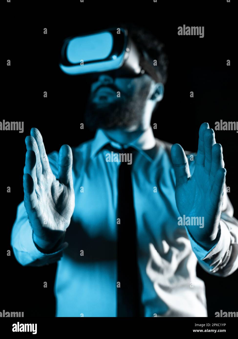 Man Wearing Vr Glasses And Presenting Important Messages Between Hands. Stock Photo