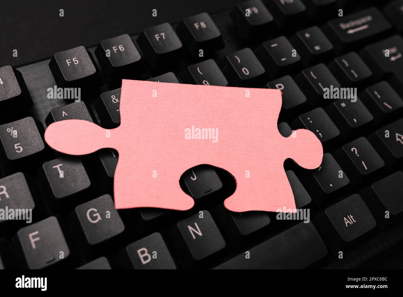 Colored sticker lying on keyboard. Important message written over paper. Stock Photo