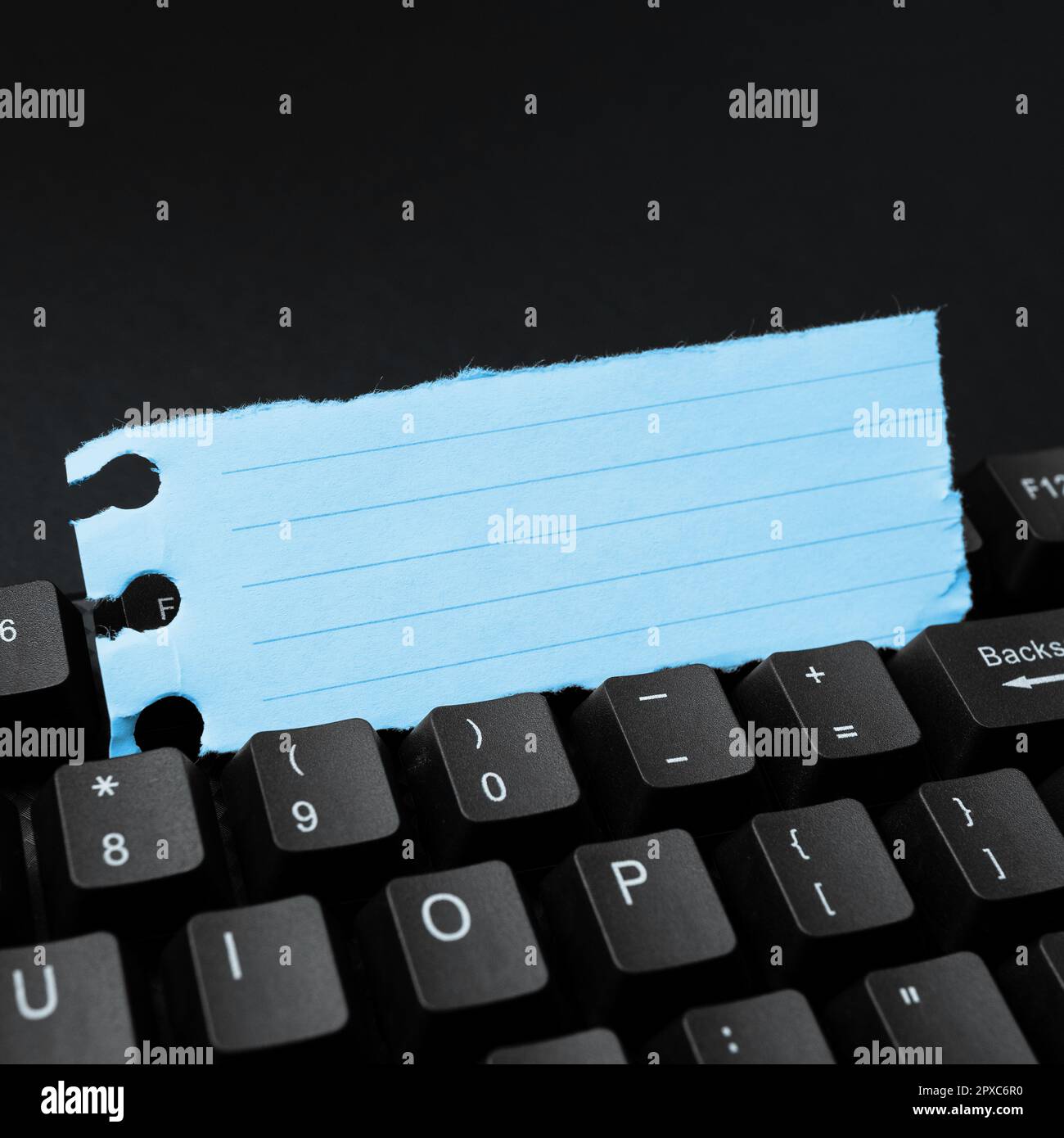 Sticker lying on black keyboard. Important message written over paper ...