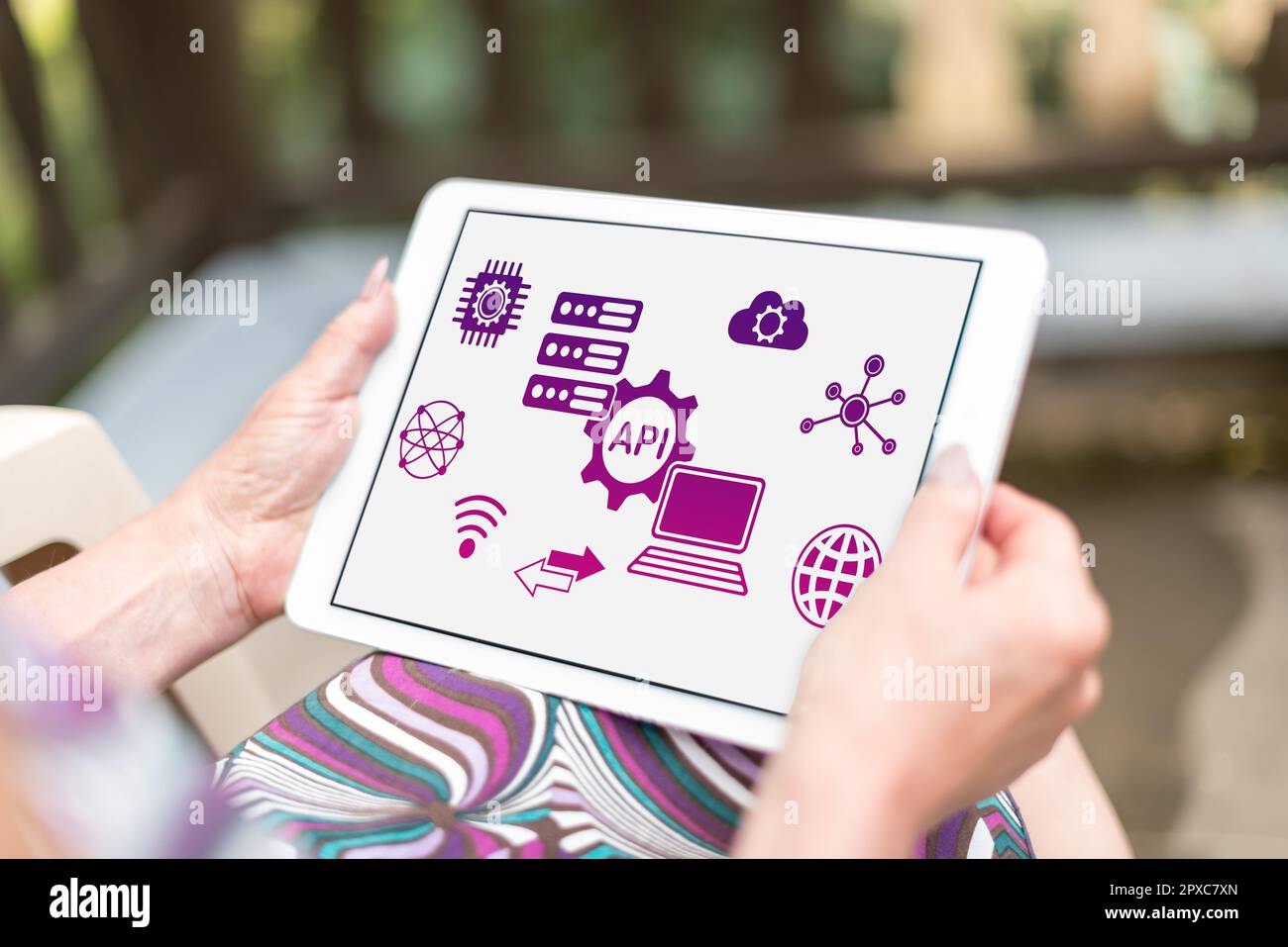 Api concept shown on a tablet held by a woman Stock Photo
