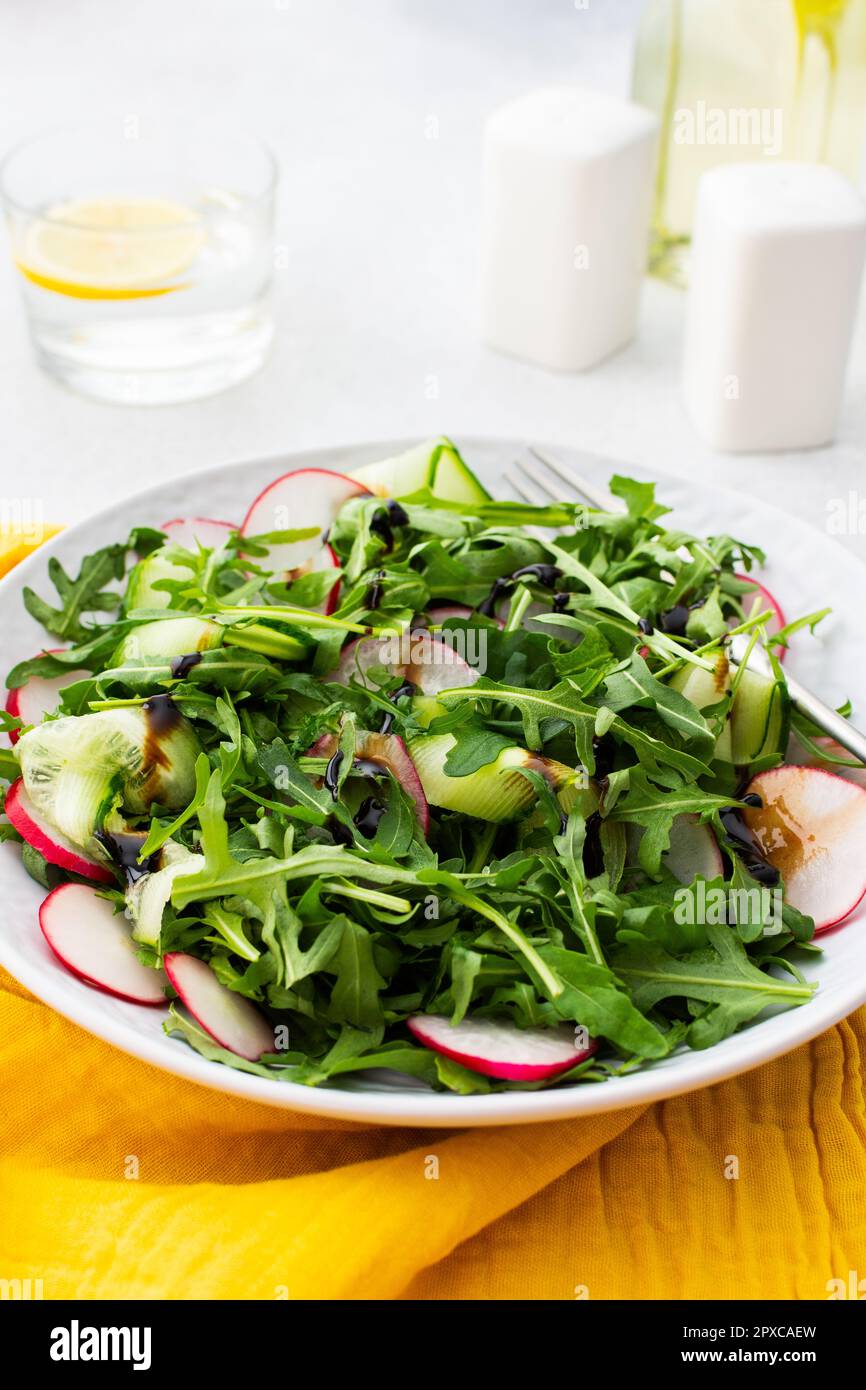 Healthy breakfasts, arugula and radish and cucumber salad with balsamic